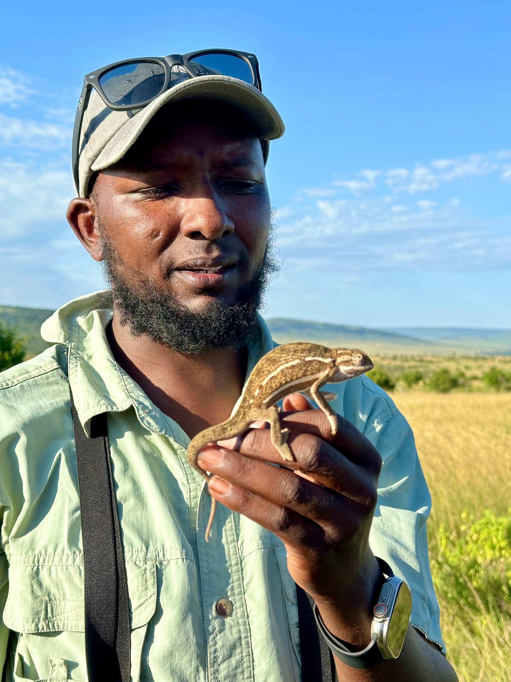 Dominic holding a chameleon — attention to small forest life on safari