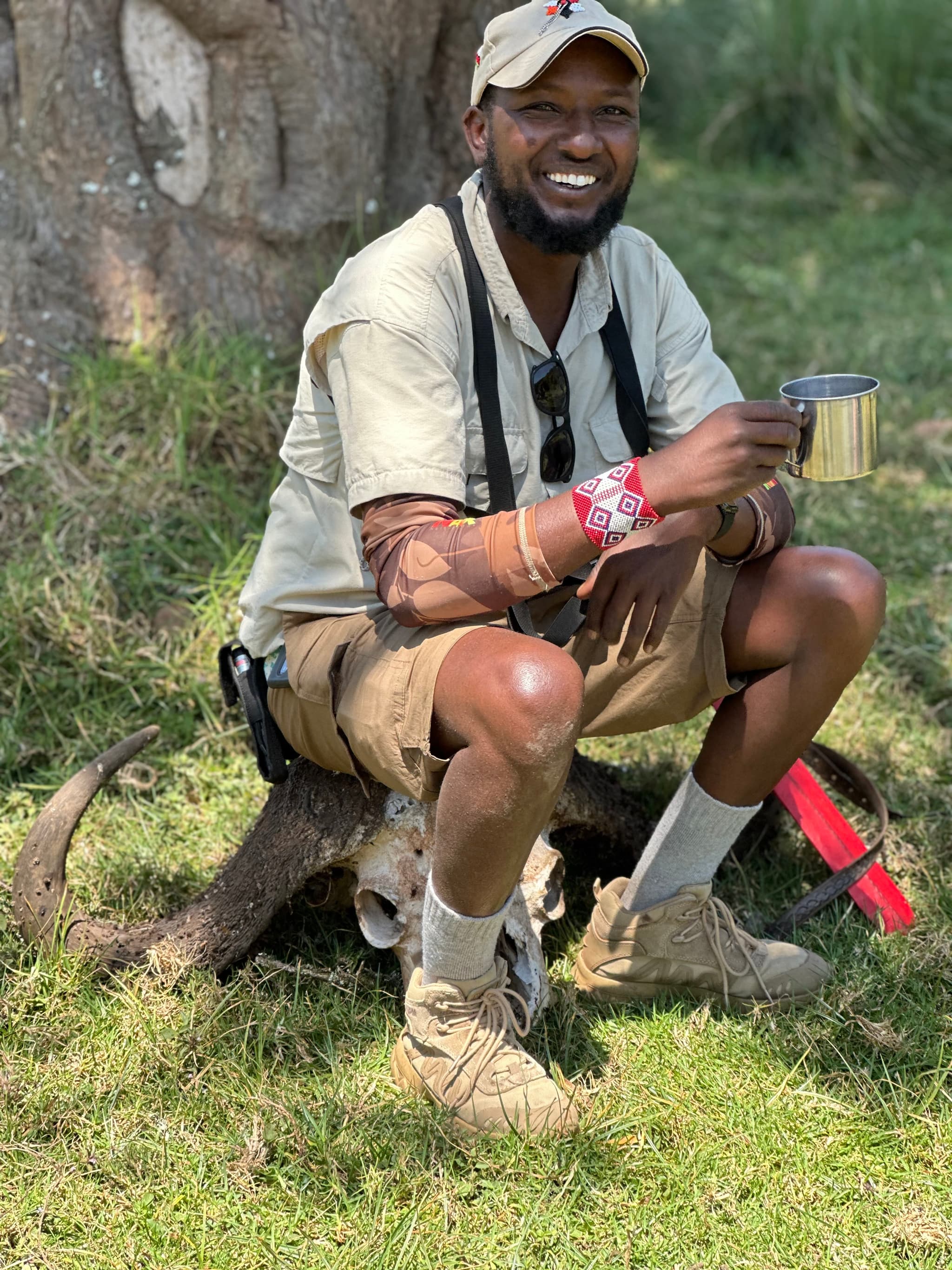 Dominic seated — safari guide at rest between drives
